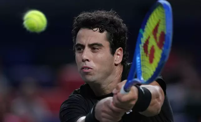 Jaume Munar, of Spain plays a backhand return to Novak Djokovic, of Serbia during the men's singles match of the Shanghai Masters tennis tournament at Qizhong Forest Sports City Tennis Center, in Shanghai, China, Tuesday, Oct. 7, 2025. (AP Photo/Andy Wong)
