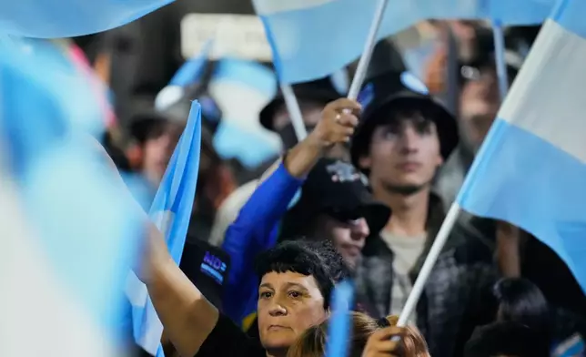Supporters of the opposition Peronist party gather at their campaign headquarters in La Plata, Argentina, after polls closed in legislative midterm elections, Sunday, Oct. 26, 2025.(AP Photo/Gustavo Garello)