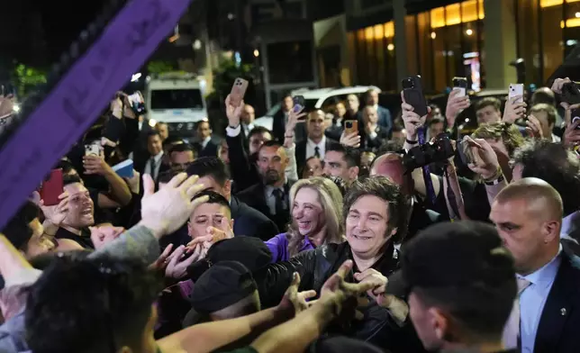 Argentina's President Javier Milei greets supporters after winning in legislative midterm elections in Buenos Aires, Argentina, Sunday, Oct. 26, 2025. (AP Photo/Rodrigo Abd)