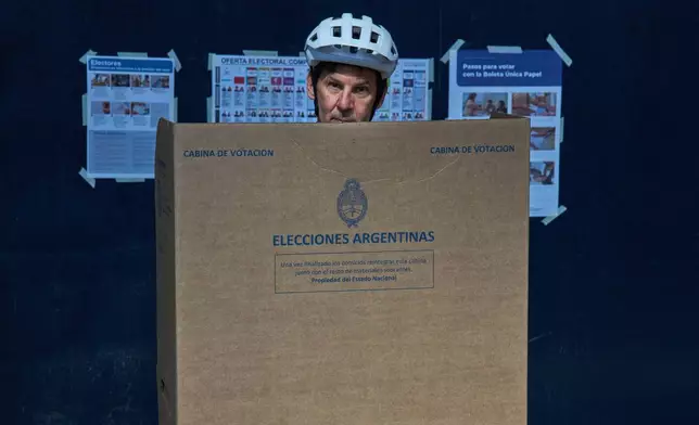 Fabian Gropper casts his vote during legislative midterm elections in Buenos Aires, Argentina, Sunday, Oct. 26, 2025. (AP Photo/Rodrigo Abd)