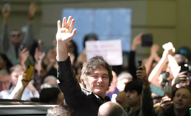 Argentina's President Javier Milei waves to supporters after voting during legislative midterm elections in Buenos Aires, Argentina, Sunday, Oct. 26, 2025. (AP Photo/Natacha Pisarenko)