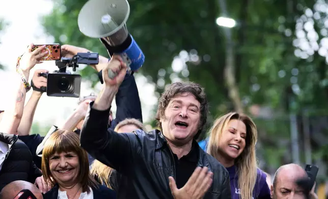 President Javier Milei holds a megaphone while leading a campaign rally ahead of legislative national elections, in Tres de Febrero, Buenos Aires province, Argentina, Friday, Oct. 17, 2025. (AP Photo/Rodrigo Abd)