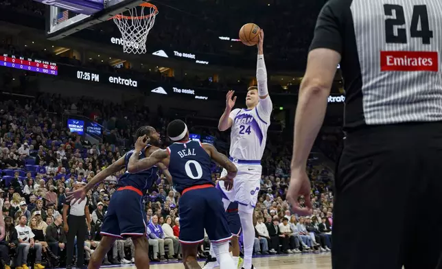 Utah Jazz center Walker Kessler, second from righ, shoots while defended by Los Angeles Clippers guard Bradley Beal (0) and forward Kawhi Leonard, left, during the first half of an NBA basketball game, Wednesday, Oct. 22, 2025, in Salt Lake City. (AP Photo/Tyler Tate)