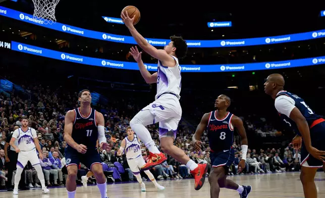 Utah Jazz guard Walter Clayton Jr. (13) goes to the basket for a lay up during the first half of an NBA basketball game, Wednesday, Oct. 22, 2025, in Salt Lake City. (AP Photo/Tyler Tate)