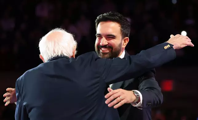 New York City mayoral candidate Zohran Mamdani, right, hugs Sen. Bernie Sanders, I-Vt., before speaking during a rally, Sunday, Oct. 26, 2025, in New York. (AP Photo/Heather Khalifa)
