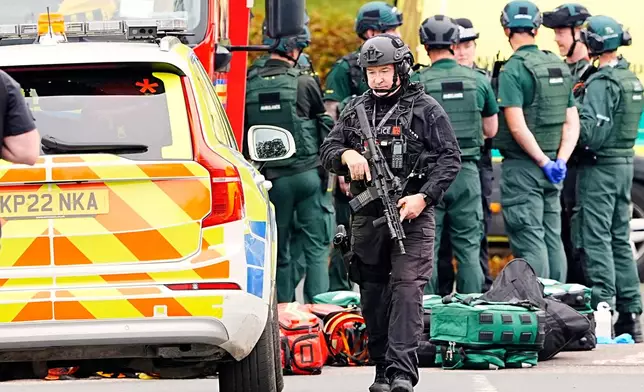 An armed police officer at the scene of a stabbing incident at Heaton Park Hebrew Congregation synagogue, in Crumpsall, Manchester, England, Thursday Oct. 2, 2025. (Peter Byrne/PA via AP)