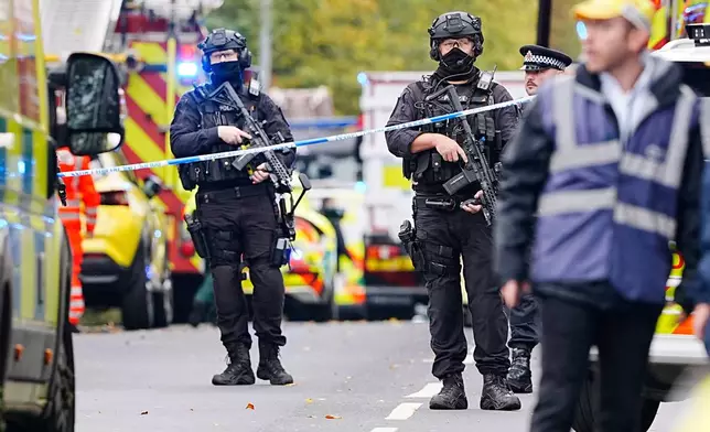 Armed police officers at the scene of a stabbing incident at Heaton Park Hebrew Congregation synagogue, in Crumpsall, Manchester, England, Thursday Oct. 2, 2025. (Peter Byrne/PA via AP)