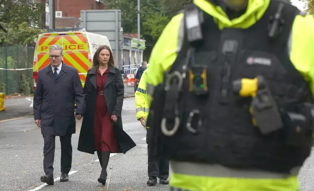 Britain's Prime Minister Keir Starmer and his wife Victoria arrive to meet emergency workers near Heaton Park Hebrew Congregation synagogue in Manchester, England, Friday, Oct. 3, 2025, where two people died in a terror attack on Thursday. (AP Photo/Ian Hodgson)