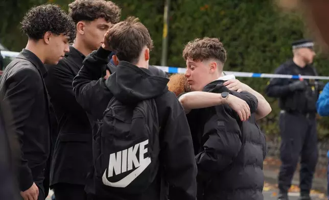 People react close to the scene of a stabbing incident at Heaton Park Hebrew Congregation synagogue, in Crumpsall, Manchester, England, Thursday, Oct. 2, 2025. (AP Photo/Ian Hodgson)