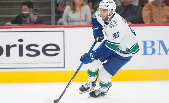 Vancouver Canucks center Max Sasson (63) handles the puck during the second period of an NHL hockey game against the Chicago Blackhawks Friday, Oct. 17, 2025, in Chicago. (AP Photo/Erin Hooley)