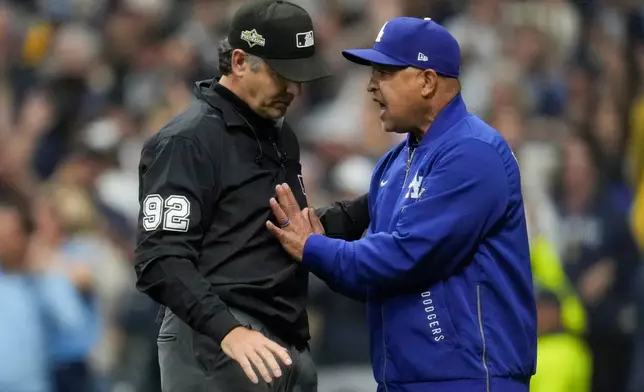 Los Angeles Dodgers manager Dave Roberts argues with umpire James Hoys during the fourth inning in Game 1 of baseball's National League Championship Series, Monday, Oct. 13, 2025, in Milwaukee. (AP Photo/Ashley Landis)