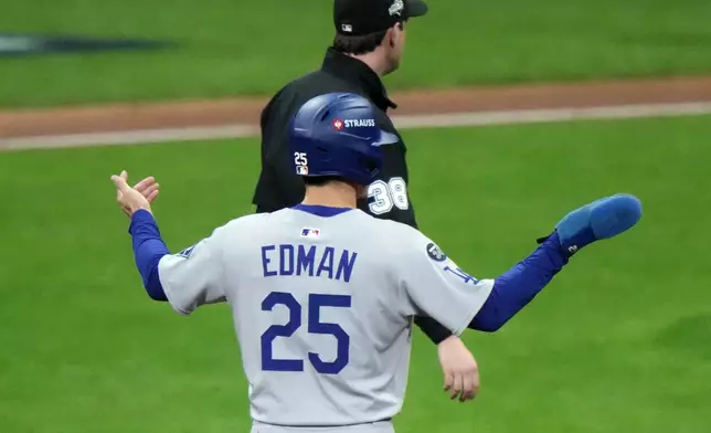 Los Angeles Dodgers' Tommy Edman reacts after a triple play during the fourth inning of Game 1 of baseball's National League Championship Series against the Milwaukee Brewers Monday, Oct. 13, 2025, in Milwaukee. (AP Photo/Morry Gash)