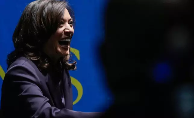 Former Vice President Kamala Harris greets people before she speaks, Friday, Oct. 17, 2025, in Birmingham, Ala. (AP Photo/Mike Stewart)