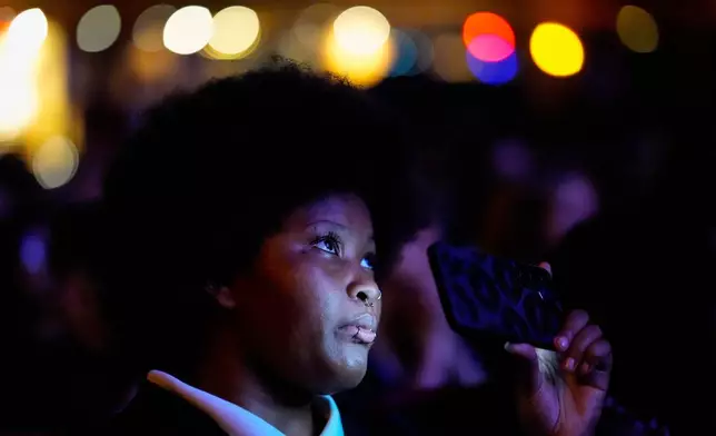 A woman listens to former Vice President Kamala Harris speak, Friday, Oct. 17, 2025, in Birmingham, Ala. (AP Photo/Mike Stewart)