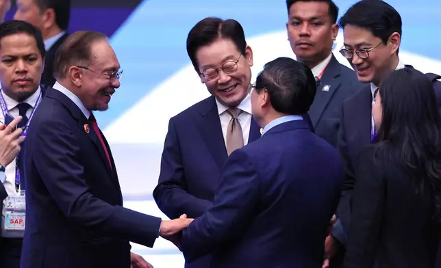 Chairman of the Association of Southeast Asian Nations (ASEAN) and Prime Minister of Malaysia Anwar Ibrahim, second left, South Korea's President Lee Jae Myung, center, and Vietnam's Prime Minister Pham Minh Chinh speak during the 26th ASEAN – Republic of Korea (ROK) Summit, as part of the 47th Association of Southeast Asian Nations (ASEAN) summit in Kuala Lumpur, Malaysia, Monday, Oct. 27, 2025. (Hasnoor Hussain/Pool Photo via AP)