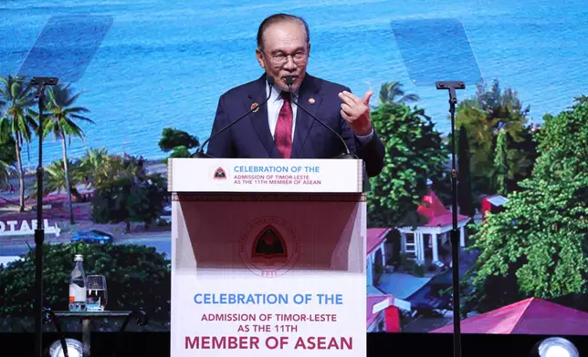 Malaysia's Prime Minister Anwar Ibrahim delivers his speech during a reception for East Timor's admission to ASEAN on the sidelines of the Association of Southeast Asian Nations (ASEAN) summit at the Kuala Lumpur Convention Centre in Kuala Lumpur, Malaysia, Monday, Oct. 27, 2025. (How Hwee Young/Pool Photo via AP)