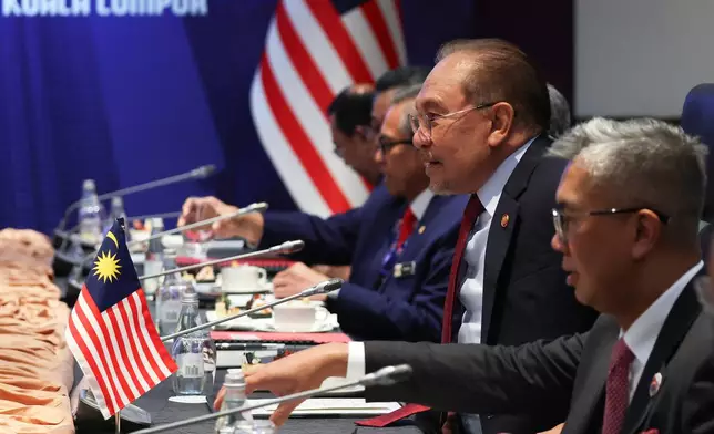 Malaysia's Prime Minister Anwar Ibrahim, second right, meets with Canada's Prime Minister Mark Carney, during a bilateral meeting on the sidelines of the Association of Southeast Asian Nations (ASEAN) Summit at the Kuala Lumpur Convention Centre (KLCC) in Kuala Lumpur, Malaysia, Monday, Oct. 27, 2025. (Fazry Ismail/Pool Photo via AP)