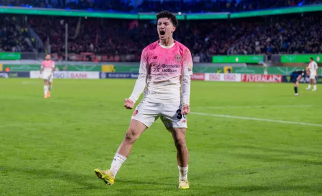 Leverkusen's Ibrahim Maza celebrates after scoring his side's third goal during a German soccer cup second round match between SC Paderborn and Bayer 04 Leverkusen in Paderborn, Germany, Wednesday, Oct. 29, 2025. (David Inderlied/dpa via AP)