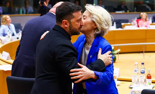European Commission President Ursula von der Leyen, right, greets Ukraine's President Volodymyr Zelenskyy during a round table meeting at an EU Summit in Brussels, Thursday, Oct. 23, 2025. (Yves Herman, Pool Photo via AP)