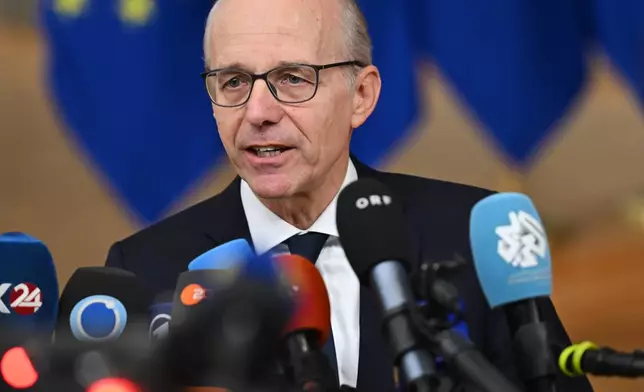 Luxembourg's Prime Minister Luc Frieden speaks with the media as he arrives for an EU Summit at the European Council building in Brussels, Thursday, Oct. 23, 2025. (AP Photo/Harry Nakos)