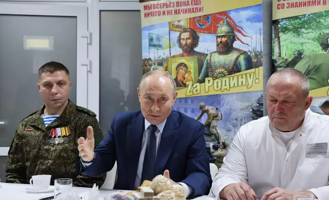 Russian President Vladimir Putin, center, talks with Russian servicemen who fought in Ukraine and Pavel Krainyukov, right, head of the Mandryk Central Military Clinical Hospital, in Moscow, Russia, Wednesday, Oct. 29, 2025. (Vladimir Gerdo, Sputnik, Kremlin Pool Photo via AP)