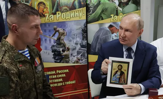 President Vladimir Putin holds the Russian Orthodox the icon of the Holy Blessed Prince Alexander Nevsky as he meets with soldiers wounded in action in Ukraine at the the Mandryk Central Military Clinical Hospital, in Moscow, Russia, Wednesday, Oct. 29, 2025. (Vyacheslav Prokofyev, Sputnik, Kremlin Pool Photo via AP)