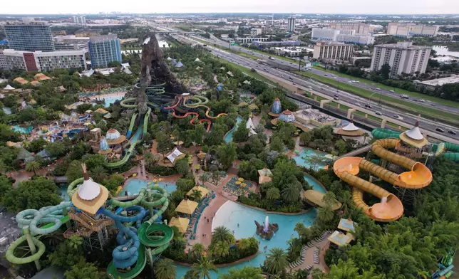 Hotels and highways are seen around Universal Volcano Bay water park, Friday, Aug. 22, 2025, in Orlando, Fla., which saw an influx of migrants in recent years drawn by warm temperatures, a vibrant migrant community, and plentiful job opportunities. (AP Photo/Rebecca Blackwell)