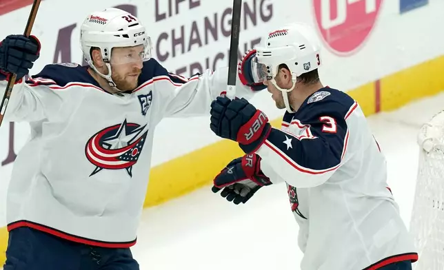Columbus Blue Jackets' Charlie Coyle (3) celebrates with Mathieu Olivier (24) after scoring during the first period of an NHL hockey game, Saturday, Oct. 25, 2025, in Pittsburgh. (AP Photo/Matt Freed)