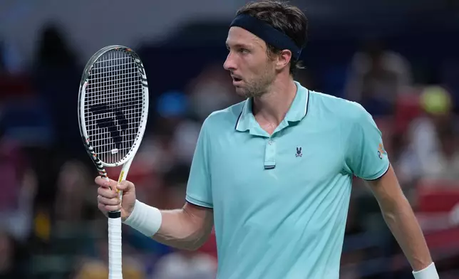 Arthur Rinderknech of France reacts after scoring a point against Alexander Zverev of Germany during the men's singles match of the Shanghai Masters tennis tournament at Qizhong Forest Sports City Tennis Center, in Shanghai, China, Monday, October. 6, 2025. (AP Photo/Andy Wong)