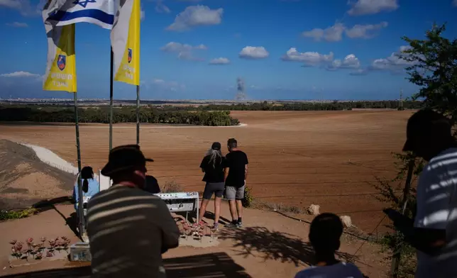 Smoke rises from an Israeli army bombardment in the Gaza Strip, seen from a memorial site for Israelis killed in the Oct. 7, 2023, Hamas attack, as Israel marks the second anniversary since the attack, Tuesday, Oct. 7, 2025. (AP Photo/Ohad Zwigenberg)