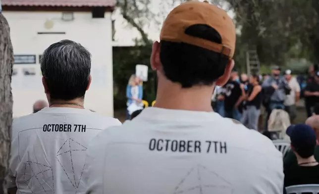 People attend a memorial service marking two years since the Oct. 7, 2023, Hamas cross-border attack on Israel, in Kibbutz Kfar Aza, southern Israel where many of its community members were Killed and abducted, Tuesday, Oct. 7, 2025. (AP Photo/Ohad Zwigenberg)