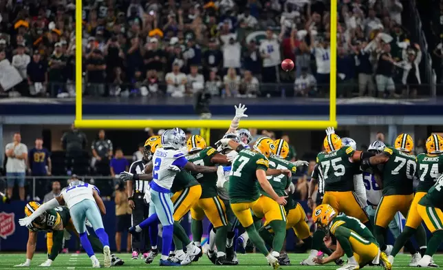 Green Bay Packers place kicker Brandon McManus (17) kicks a field goal to tie the game late in the second half of an NFL football game against the Dallas Cowboys Sunday, Sept. 28, 2025, in Arlington, Texas. (AP Photo/Jeffrey McWhorter)