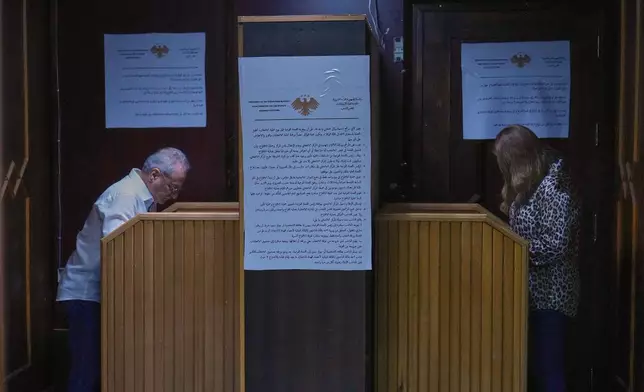 A Syrian electoral college member fills his ballot at the secret room during a parliamentary election at Latakia's Governor ballot station, in the coastal city of Latakia, Syria, Sunday, Oct. 5, 2025. (AP Photo/Hussein Malla)