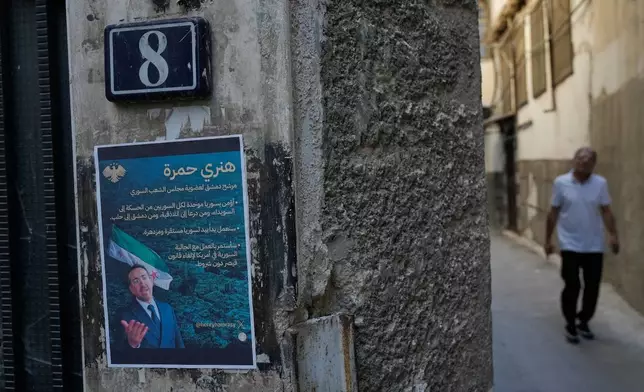 A poster shows Syrian-American Jew Henry Hamra, a candidate for the Syrian Parliamentary elections, in the Jewish neighborhood of old Damascus, Syria Friday, Oct. 3, 2025. (AP Photo/Hussein Malla)