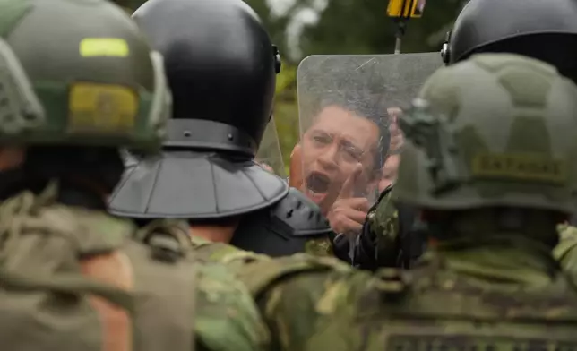 A man faces off with soldiers during an anti-government protest in Quito, Ecuador, Oct. 15, 2025. (AP Photo/Dolores Ochoa)