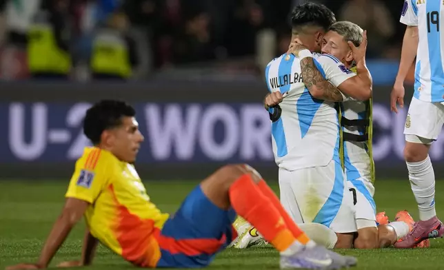 Argentina's Juan Villalba embraces teammate Gianluca Prestianni after they defeated Colombia 1-0 in a FIFA U-20 World Cup semifinal soccer match at the National Stadium in Santiago, Chile, Oct. 15, 2025. (AP Photo/Esteban Felix)