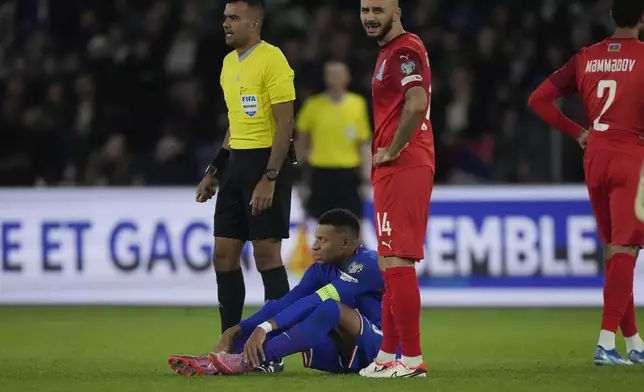 France's Kylian Mbappe sits injured during a World Cup 2026 Group D qualifying soccer match between France and Azerbaijan in Paris, France, on Friday, Oct. 10, 2025. (AP Photo/Michel Euler)