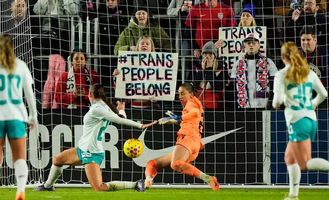 A ball kicked by United States forward Catarina MacArio (20) gets past New Zealand defender Mackenzie Barry, center left, and goalkeeper Victoria Esson, center right, to score a goal during the first half of a women's international friendly soccer match, Wednesday, Oct. 29, 2025, in Kansas City, Mo. (AP Photo/Charlie Riedel)