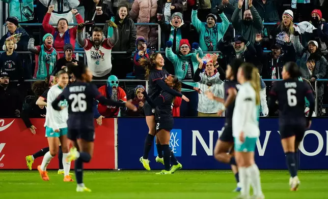 United States forward Emma Sears, center left, celebrates with forward Michelle Cooper, center right, after scoring a goal during the first half of a women's international friendly soccer match against New Zealand, Wednesday, Oct. 29, 2025, in Kansas City, Mo. (AP Photo/Charlie Riedel)