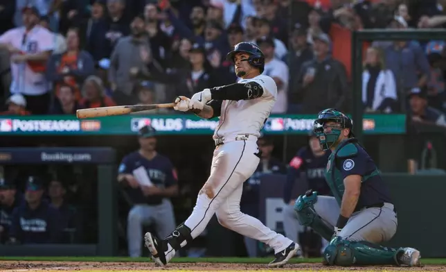 Detroit Tigers' Javier Báez watches his two-run home run during the sixth inning in Game 4 of baseball's American League Division Series against the Seattle Mariners Wednesday, Oct. 8, 2025, in Detroit. (AP Photo/Ryan Sun)
