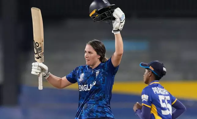 England's captain Nat Sciver-Brunt celebrates her century during the ICC Women's Cricket World Cup match between England and Sri Lanka at Premadasa Stadium in Colombo, Sri Lanka, Saturday, Oct. 11, 2025. (AP Photo/Eranga Jayawardena)