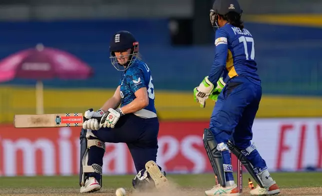 England's Emma Lamb looks back after being bowled during the ICC Women's Cricket World Cup match between England and Sri Lanka at Premadasa Stadium in Colombo, Sri Lanka, Saturday, Oct. 11, 2025. (AP Photo/Eranga Jayawardena)