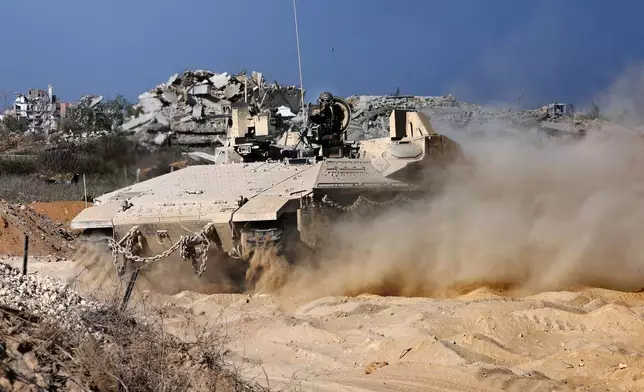 This picture taken during a media tour organised by the Israeli army shows an Israeli army vehicle manoeuvring at a position in the vicinity of the Jordanian Field Hospital in Gaza City, Friday, Oct. 3, 2025. (Jack Guez/Pool Photo via AP)