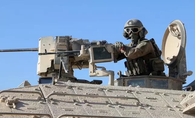 This picture taken during a media tour organised by the Israeli army shows an Israeli army soldier behind a mounted machine gun in the vicinity of the Jordanian Field Hospital in Gaza City, Friday, Oct. 3, 2025. (Jack Guez/Pool Photo via AP)