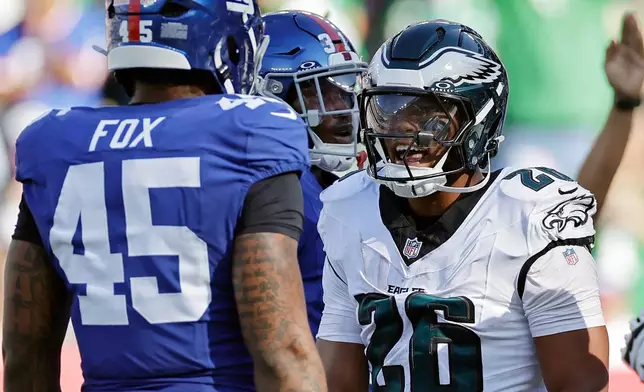 FILE - Philadelphia Eagles running back Saquon Barkley (26) yells at New York Giants linebacker Tomon Fox (45) during an NFL football game Sunday, Oct. 20, 2024, in East Rutherford, N.J. (AP Photo/Adam Hunger, File)