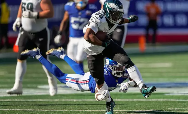 FILE - Philadelphia Eagles running back Saquon Barkley (26) carries the ball against the New York Giants during the third quarter of an NFL football game, Sunday, Oct. 20, 2024, in East Rutherford, N.J. (AP Photo/Seth Wenig, File)