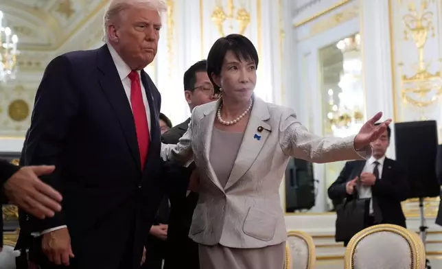 President Donald Trump, left, is escorted by Japan's Prime Minister Sanae Takaichi during a meeting with families of Japanese abductees by North Korea at Akasaka Palace in Tokyo, Japan, Tuesday, Oct. 28, 2025. (AP Photo/Mark Schiefelbein)