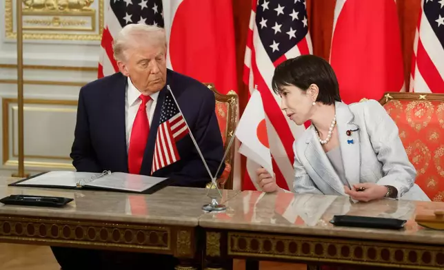 U.S. President Donald Trump, left, and Japan's Prime Minister Sanae Takaichi attend a signing ceremony at Akasaka Palace state guest house in Tokyo Tuesday, Oct. 28, 2025. (Kiyoshi Ota/Pool Photo via AP)