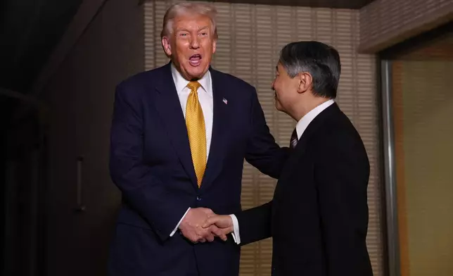 President Donald Trump, left, and Japan's Emperor Naruhito shake hands during their meeting at the Imperial Palace in Tokyo, Oct. 27, 2025. (Issei Kato/Pool Photo via AP)
