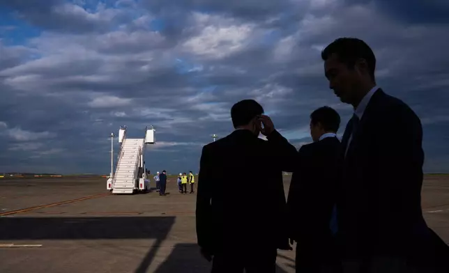 Security personnel take position just before the arrival of President Donald Trump in Air Force One at Haneda International Airport in Tokyo, Monday, Oct. 27, 2025. (AP Photo/Louise Delmotte)